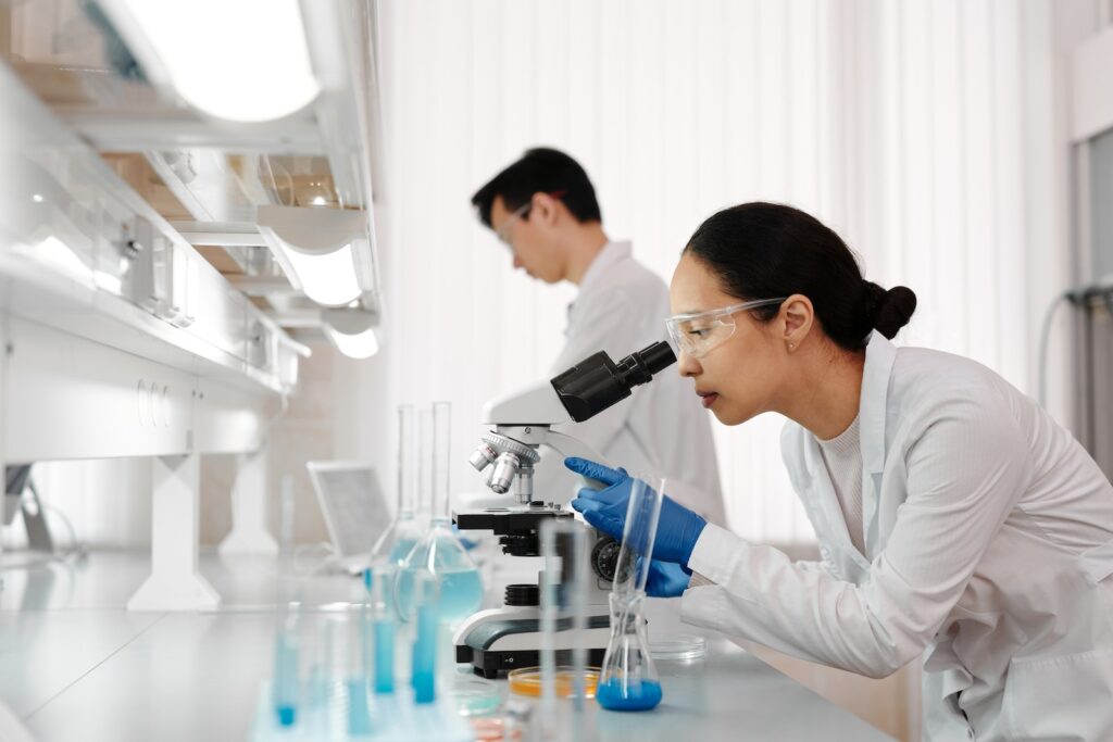 Woman using the microscope in a laboratory checking for mold